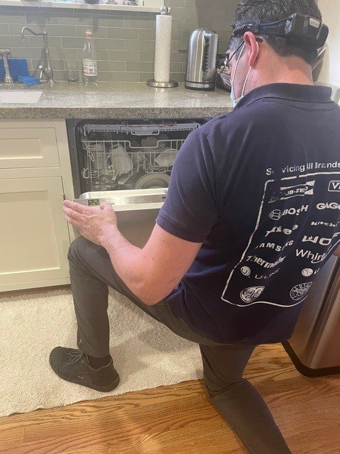 Technician fixing dishwasher