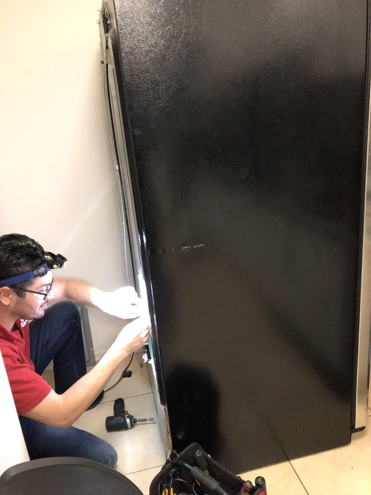 Technician installing compressor