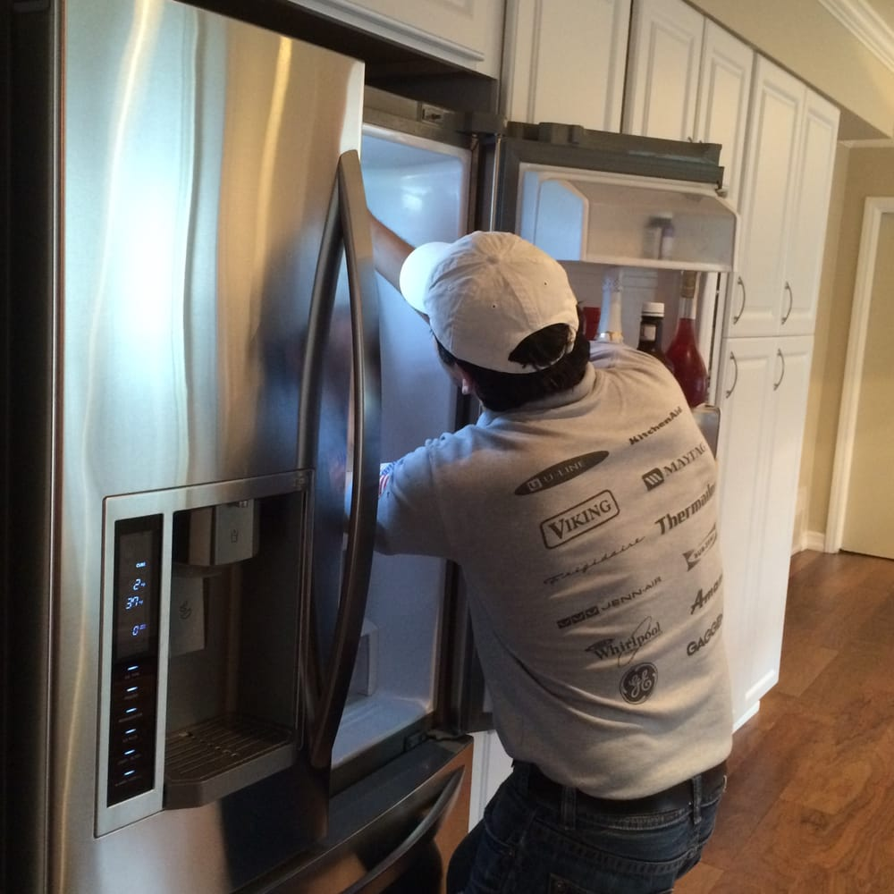 Technician repairing fridge